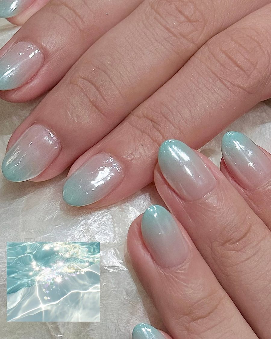 Aqua chrome ombre gel on almond nails.