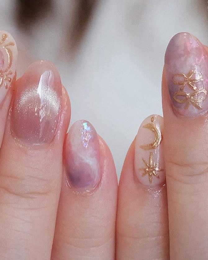 Lilac and pink cat eye gel with small gold charms.