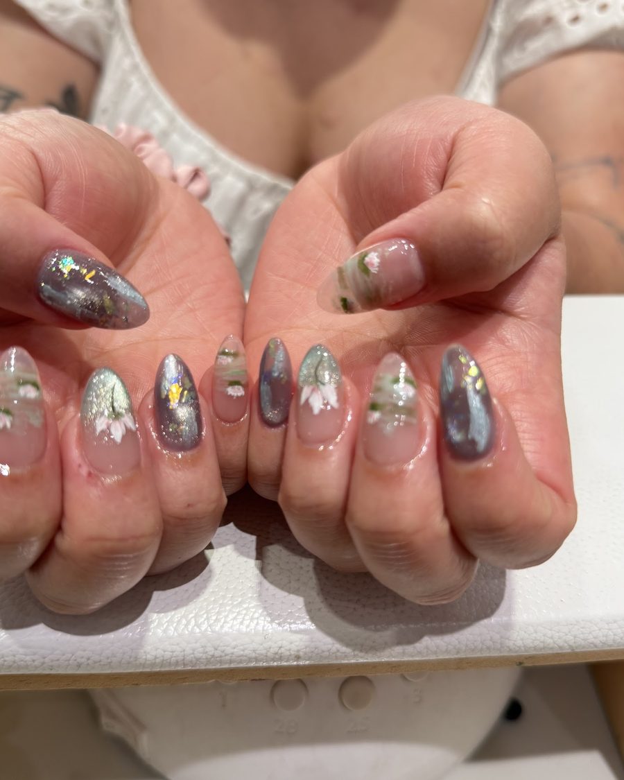 Grey and clear gel with gold flake and small flowers.
