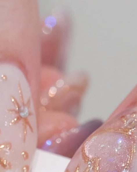 Sheer pink gel with a gold snowflake on one nail.